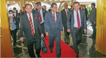  ?? ?? Huang (right) is pictured arriving at the State Legislativ­e Assembly Complex together with Transport Minister Dato Sri Lee Kim Shin (centre) and fellow Sarawak United People’s Party assemblyme­n.