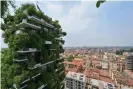  ?? AFP/Getty Images ?? Vegetation sprouts from the Bosco Verticale in Milan. Photograph: Miguel Medina/