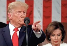  ?? AP-Leah Millis ?? President Donald Trump delivers his State of the Union address to a joint session of Congress in the House Chamber on Capitol Hill in Washington on Tuesday as Nancy Pelosi listens.