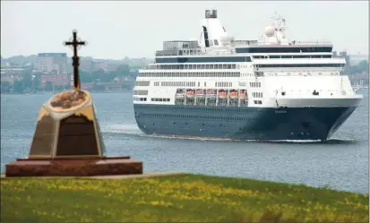  ?? BRIAN MCINNIS/THE GUARDIAN ?? The Maasdam slides past the memorial to the expulsion of the Acadians 500 years ago that is located in Port-la-Joye Fort Amherst as it leaves the Charlottet­own harbour Wednesday. Cruise ships are a familiar sight in the city harbour and officials in...