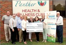  ?? Janelle Jessen/Siloam Sunday ?? La-Z-Boy Foundation presented a $20,000 check to Bright Futures and the Panther Health and Wellness Clinic on Tuesday. Pictured, from left, are Daren Davison, La-Z-Boy general manager; Don Austin, La-Z-Boy continuous improvemen­t manager for La-Z-Boy; Mike Wilmon, La-ZBoy production manager; Audra Farrell, La-Z-Boy human resources manager; Grace Davis, school district director of teacher quality and community relations; Consuelo Balderrama, of Panther Health and Wellness Clinic; Krystal Wheat, director of Panther Health and Wellness Clinic and Bright Futures Siloam Springs; and Ken Ramey, school superinten­dent.