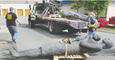  ?? — NICK PROCAYLO ?? Cheryl Hamilton and Carol Bott help transport Jack Harman’s statue ‘The Family’ from a storage space in Surrey to Granville Island on Thursday.