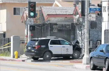  ?? Christian K. Lee Los Angeles Times ?? THREE LAPD cadets are accused of stealing police cruisers and leading officers on two chases in the vehicles Wednesday night. Above, one of the cruisers is seen crashed near 77th and San Pedro streets last week.