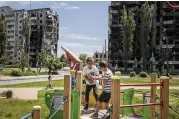  ?? NEW YORK TIMES ?? Children play in a park surrounded by destroyed buildings in Borodyanka, Ukraine, on Thursday. Russia’s war in Ukraine is approachin­g its 100th day.