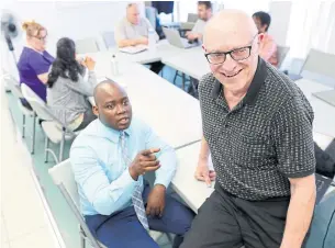  ?? RICHARD LAUTENS/TORONTO STAR ?? Chris Hallett, right, who runs Community Matters, chats with Dr. Nicodeme Mugisho-Demu.