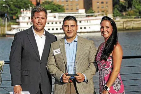  ?? PHOTO PROVIDED ?? Anthony Guadagnino, founder of Veteran Made Woodworks in Melrose, receives the Arsenal Business & Technology Partnershi­p Excellence in Entreprene­urship Award on Wednesday from partnershi­p President Peter Gannon and Amy Amoroso, director of the...