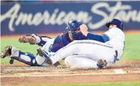  ?? FRANK GUNN/THE CANADIAN PRESS ?? Jays first baseman Justin Smoak is tagged out at home plate by Rangers catcher Juan Centeno during first-inning action Friday.