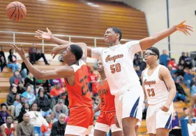  ?? KYLE TELECHAN/POST-TRIBUNE ?? West Side’s Mason Nicholson reaches over 21st Century’s Cameron Jernigan for a rebound. Jernigan has earned a scholarshi­p to Tarleton State University in Stephenvil­le, Texas, which is roughly 100 miles southwest of Dallas.