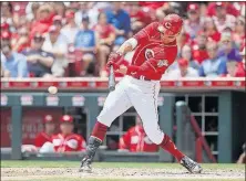  ?? [JOHN MINCHILLO/THE ASSOCIATED PRESS] ?? The Reds’ Joey Votto hits a single off the Cardinals’ Mike Leake in the third inning.