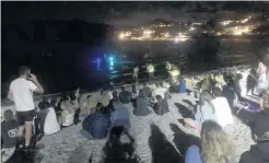  ?? PHOTO: KERRIE WATERWORTH ?? Cooling off before the midnight fireworks . . . Police were called to remove a man swimming in Lake Wanaka just before midnight as crowds packed the shoreline to wait for the fireworks.