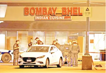  ??  ?? Police officers stand in front of Bombay Bhel restaurant, where two unidentifi­ed men set off a bomb late Thursday night, wounding more than a dozen people, in Mississaug­a, Ontario. — AFP photo