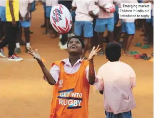  ??  ?? Emerging market Children in India are introduced to rugby