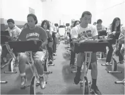  ?? STEVEN S. HARMAN, THE ( NASHVILLE) TENNESSEAN ?? High school students pedal FitDesks as they read in Nashville.