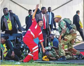  ?? Reuters ?? Emergency services staff attend to people injured in an explosion during a rally by Zimbabwean President Emmerson Mnangagwa in Bulawayo, Zimbabwe on Saturday.