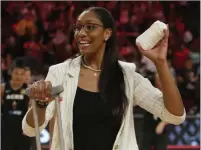  ?? Michael Blackshire Las Vegas Review-journal ?? Injured Aces forward A’ja Wilson throws T-shirts into the crowd at Mandalay Bay Events Center on Sunday after a 79-74 victory against the Minnesota Lynx.