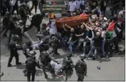  ?? MAYA LEVIN — THE ASSOCIATED PRESS ?? Israeli police confront with mourners as they carry the casket of slain Al Jazeera veteran journalist Shireen Abu Akleh during her funeral in east Jerusalem on Friday.