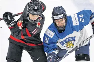  ??  ?? Canada’s Jill Saulnier battles Finland’s Noora Tulus during the 2019 world women’s hockey championsh­ip in Espoo, Finland.