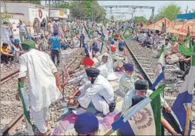  ?? ANI ?? Members of farmer unions block tracks at the Shambhu railway station on Wednesday.