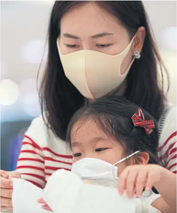  ??  ?? BEATING PROFITEERS: A mother and her child attends a “DIY face mask” workshop at Seacon Square in Prawet district in Bangkok. The workshop teaches the public to make their own face masks to wear.