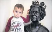 ??  ?? Aliyan Chaudhary, 14 months, with a bust of Queen Elizabeth II