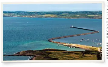  ?? NIGEL WILKINS/ALAMY ?? Holyhead’s distinctiv­e ‘Z’-shaped breakwater was, when it opened in 1873, one of the longest in Europe, and nearly 150 years after it was finished it’s still an imposing structure. Eagle-eyed readers will be able to see the old locomotive shed in the bottom right of the photograph and the trackbed to the quarry.