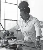  ?? COURTNEY HERGESHEIM­ER/COLUMBUS DISPATCH ?? Jovanna Robinson works in her studio at 400 W. Rich St., where she makes and sells travel bags, totes and handbags under her brand Tone Bekka.