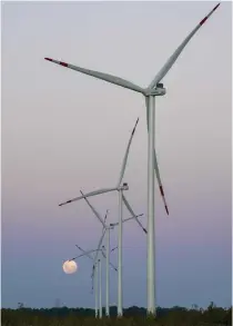  ?? Photo by Ivan PISARENKO / AFP ?? Employment growth is expected to surge for wind turbine technician­s. Photo shows windmills in front of a waxing gibbous moon in Vivorata, Buenos Aires province, on January 24, 2024.