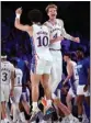  ?? TIM AYLEN – BAHAMAS VISUAL /AP ?? Jalen Wilson, center left, and Gradey Dick celebrate Kansas' overtime win over Wisconsin on Thursday.