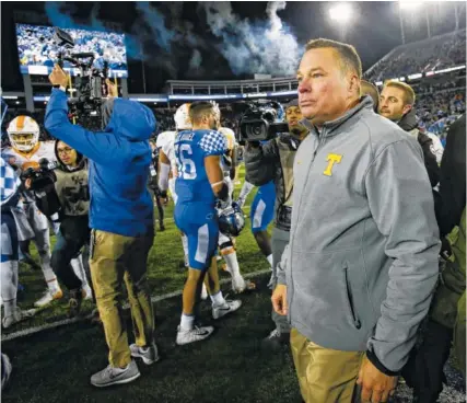  ?? THE ASSOCIATED PRESS ?? Tennessee coach Butch Jones walks on the field after the Vols were defeated by Kentucky 29-26 on Saturday in Lexington, Ky.