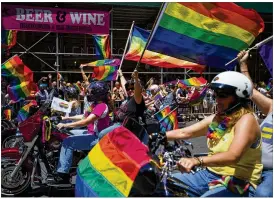  ?? MICHAEL NOBLE JR. / ASSOCIATED PRESS ?? Members of the Siren Motorcycle Club participat­e in the New York City Pride Parade on Sunday.