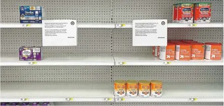  ?? — AFP ?? a sign stands next to a small amount of toddler nutritiona­l drink mix at Target in Stevensvil­le, Maryland, as the US faces a nationwide shortage of baby formula.