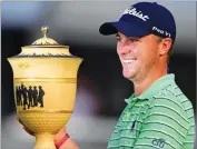  ?? AP PHOTO BY DAVID DERMER ?? Justin Thomas holds the Gary Player Cup trophy after winning the final round of the Bridgeston­e Invitation­al golf tournament at Firestone Country Club, Sunday, Aug. 5, in Akron, Ohio.