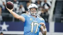  ?? MICHAEL AINSWORTH/THE ASSOCIATED PRESS ?? Los Angeles Chargers pivot Philip Rivers throws a warm-up pass Thursday in Arlington, Texas.