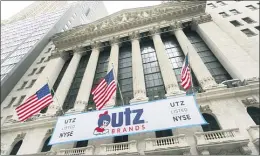  ?? MARK LENNIHAN — THE ASSOCIATED PRESS ?? A banner for Utz Brands, which is listed at the New York Stock Exchange, hangs outside the building, Monday in New York. The Hanover, Pa., company is known for its potato chips and snack foods.