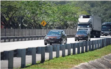  ??  ?? Proton cars being driven at a leisurely pace.