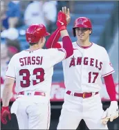  ?? ASHLEY LANDIS — THE ASSOCIATED PRESS ?? The Angels’ Max Stassi accepts congratula­tions from Shohei Ohtani after he homered in the first inning Tuesday.
