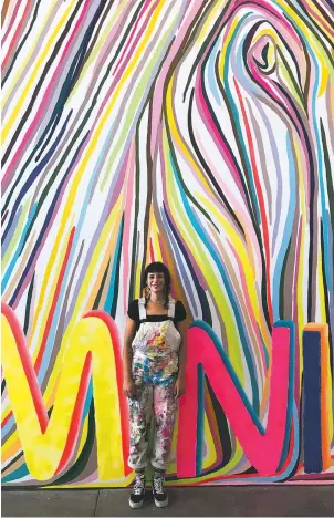  ?? Queer Indigenous Feminisms, ?? Haley Greenfeath­er English in front of her 2020 mural courtesy 516 ARTS images