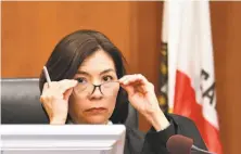  ?? Josh Edelson / AFP / Getty Images ?? San Francisco Superior Court Judge Suzanne Ramos Bolanos reads the verdict in the case against Monsanto.