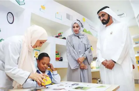  ?? WAM ?? Shaikh Mohammad with officials during a tour of the Ministry of Community Developmen­t yesterday.