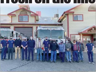  ?? Shelly Thorene / Union Democrat ?? Sonora City Fire Chief Aimee New (eighth from right) and a group of firefighte­rs and some family members pose in front of the new engine on Monday.