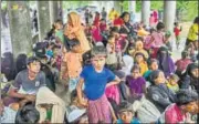  ?? AFP ?? Rohingya refugees take shelter against the rain at a registrati­on center in Bangladesh's Ukhia district on Friday.