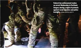  ?? ALISHA JUCEVIC/GETTY ?? Federal law enforcemen­t makes an arrest Wednesday in Portland, Oregon, during a night of protests against racial injustice and police brutality.