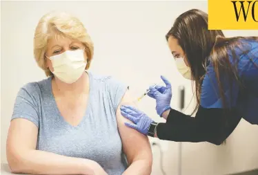  ?? JOHN MANIACI / UW HEALTH / HANDOUT VIA REUTERS ?? RN clinical staff educator Diane Mikelsons receives a mock Pfizer shot during a staff COVID-19 vaccine training session at the UW Health medical centre in Madison, Wisc., on Tuesday.