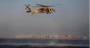  ?? (Amir Cohen/Reuters) ?? AN IAF HELICOPTER flies off the coast of Ashdod during a combined exercise with the navy in September.