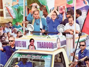  ?? S. MAHINSHA ?? Congress leader Priyanka Gandhi with UDF candidate Shashi Tharoor and senior leader Ramesh Chennithal­a during a roadshow at Poonthura in Thiruvanan­thapuram on Saturday.