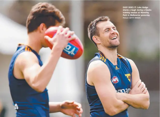  ?? Picture: GETTY IMAGES ?? EASY DOES IT: Luke Hodge shares a laugh during a Hawks training session at Waverley Park in Melbourne yesterday.