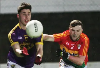  ??  ?? Goalscorer Mikie Dwyer is challenged by Carlow defender Conor O’Doherty.