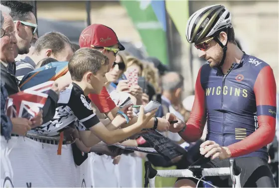  ??  ?? 2 Sir Bradley Wiggins signs autographs prior to stage one of the Tour of Britain in Glasgow. Wiggins finished a distant 111th.