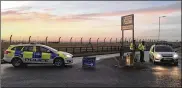  ?? SAM RUSSELL / PRESS ASSOCIATIO­N ?? British police Monday secure the area around the Royal Air Force Mildenhall base after a disturbanc­e. Media reports said a car tried to ram the gates of the base used by the U.S. Air Force.