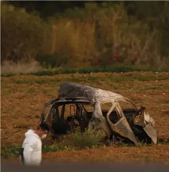  ?? Reuters ?? Forensic examiners search the remains of a car in Bidnija, Malta, in which Daphne Caruana Galizia, below, was killed. She was a sharp critic of island leaders